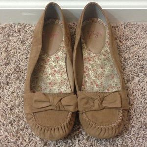 Tan flats with cute little bow on the top/front.