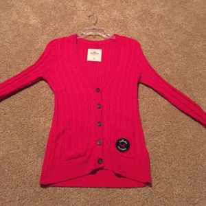 Red V neck sweater with buttons down the middle