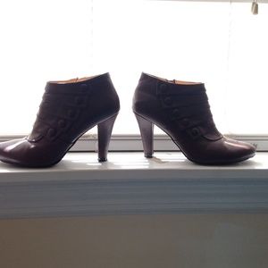 Brown leather booties with a heel and side zipper