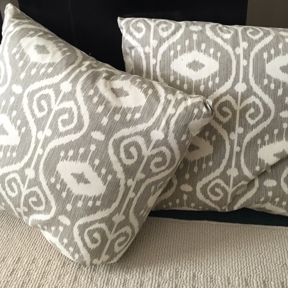 Two ivory and dark beige, patterned pillows.