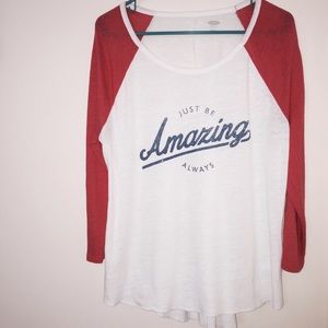 A white with orange sleeved baseball T.