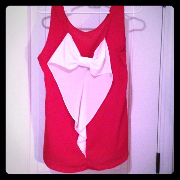 Sleeveless sheer top with giant bow on back
