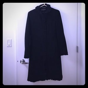 Black winter coat with ruffle trim details