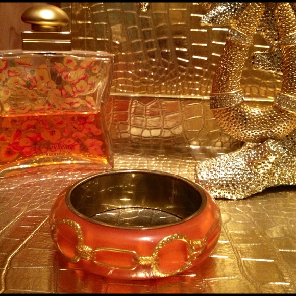 Orange bracelet with brass chain links.