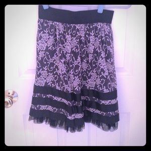Black lace skirt with ribbon detailing.