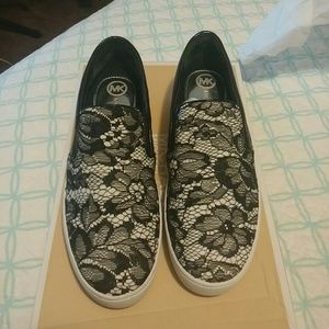 Michael kors tennis shoes and black blazer..