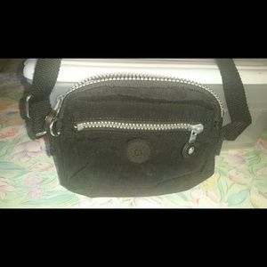 Black small Kipling sling bag.