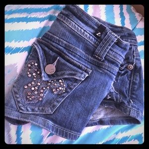 Medium wash denim shorts.