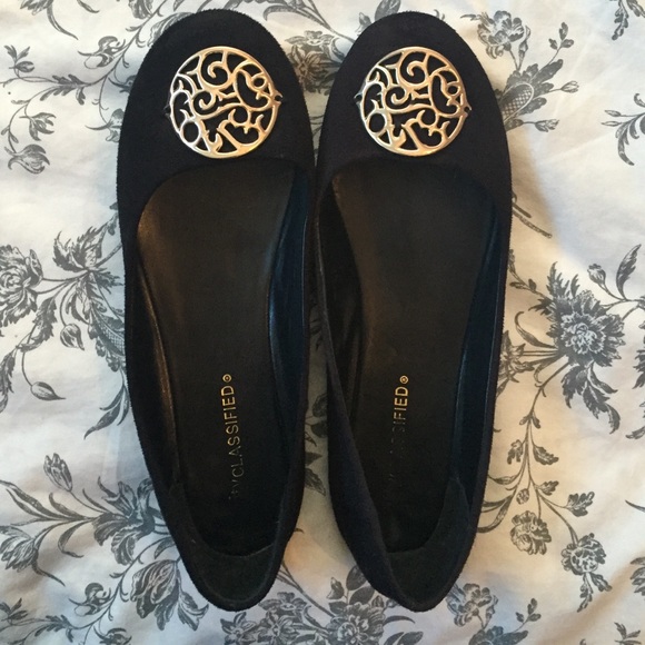 Black flats with gold emblem