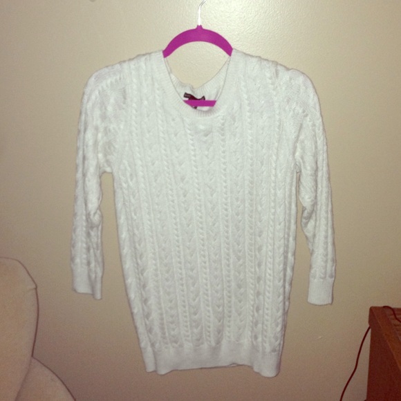 Cream colored cable-knit sweater