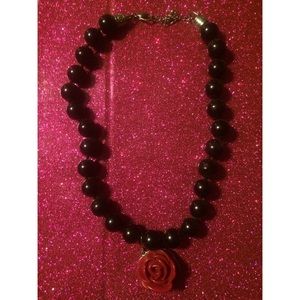 Super fun black necklace with red rose