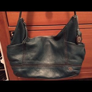 The Sak teal colored purse