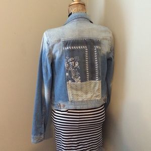 Denim jacket with pop print on the back.