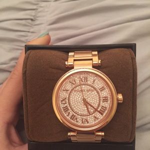 Women's rose gold Michael Kors watch.