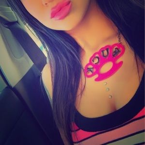 Hot pink brass knuckles necklace.