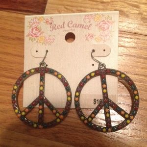 Red camel peace sign earrings.