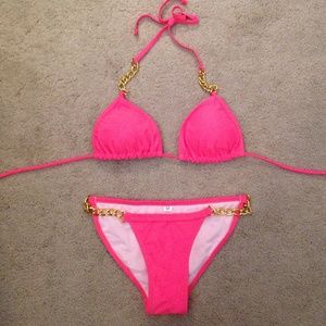 Pink bikini with gold chains. Sexy swimsuit.