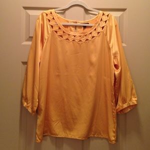 Bright yellow top with detail around collar.