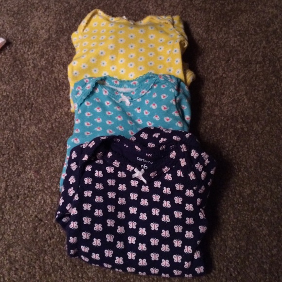 Three colorful long sleeve onesies