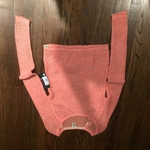 A roxy orange sweater with tags still on.