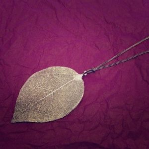 Long gold leaf necklace.