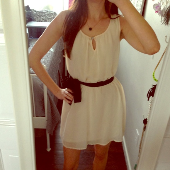 Ivory sleeveless sheath dress with black sash