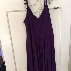 V neck purple dress with pleated skirt.