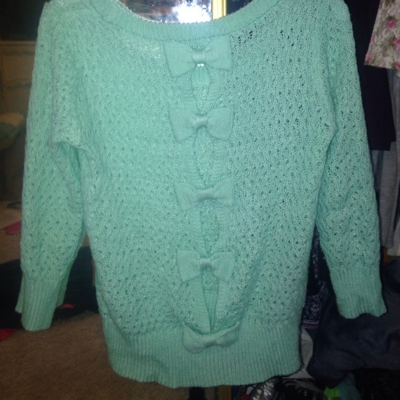Mint green sweater. Bows down back.