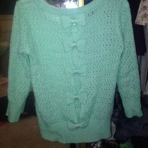 Mint green sweater. Bows down back.