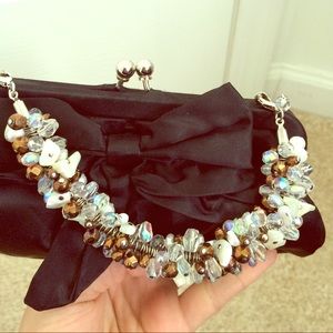 Beaded handle satin clutch