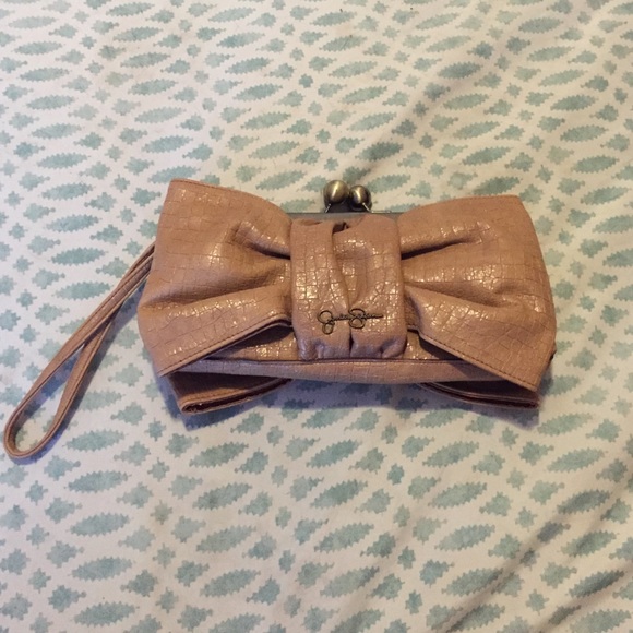 Tan bow shaped clutch.