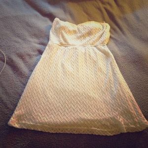 White dress with a sweetheart neck line.