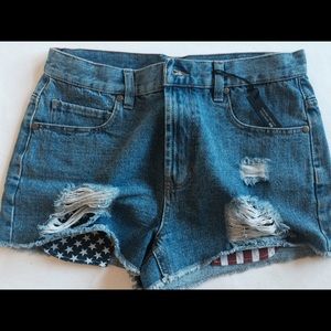 Distressed patriotic high rise denim shorts.