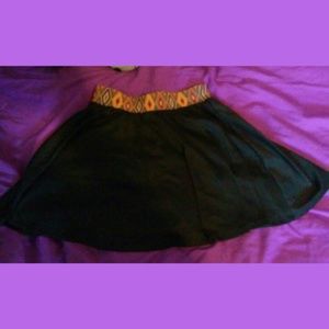 Cute black skirt with Pattern on top.