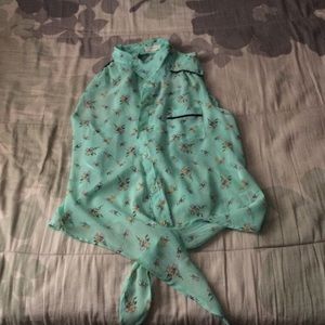 Sheer top. Fits a bit small. Ties at the bottom