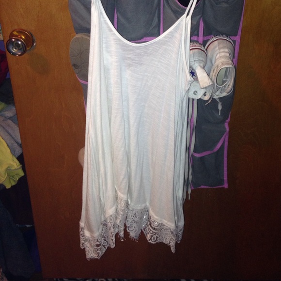 White dress/ shirt with lace on bottom.