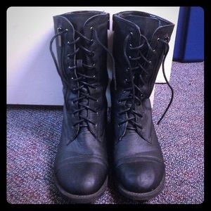 Black tie up combat boots.