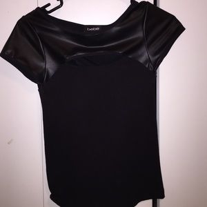 Bebe black top, small round opening in the front.