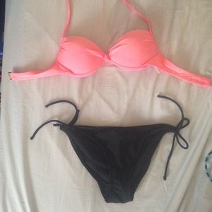 Pink bikini top and black bottoms