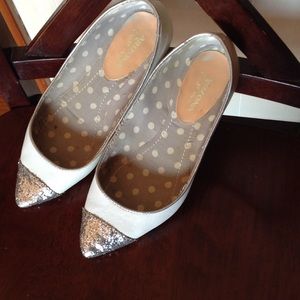 White pointed toe ballet flats.