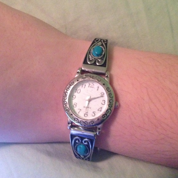 A silver and blue small watch
