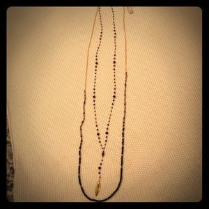 Gold and black beaded necklace with feather charm