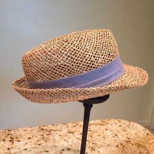 Fedora. Made of stretchy straw w/ blue-ish band