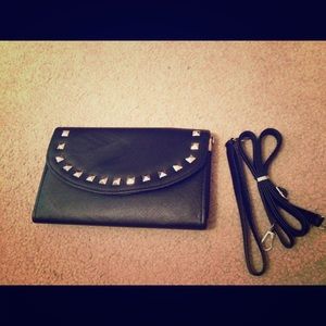 Black purse with straps and carrying handle