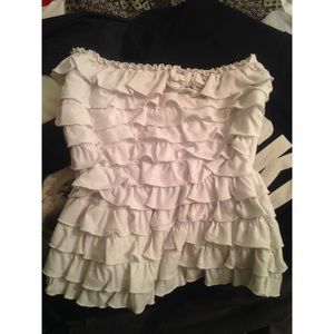 Sleeveless white crop top with ruffles