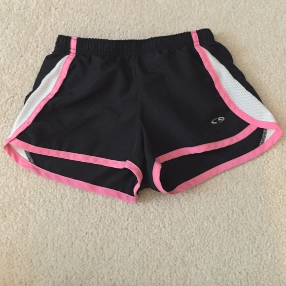 Black athletic shorts with pink trim