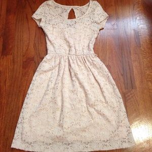 A cream crochet dress.