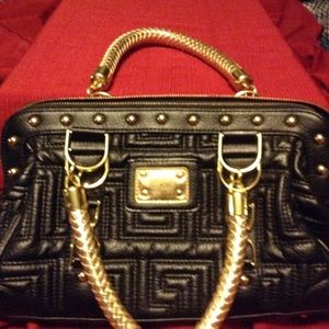 Black and gold handbag. Size is 10 x 7.