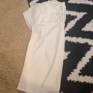 White sheer top w/ slit and bow on the back