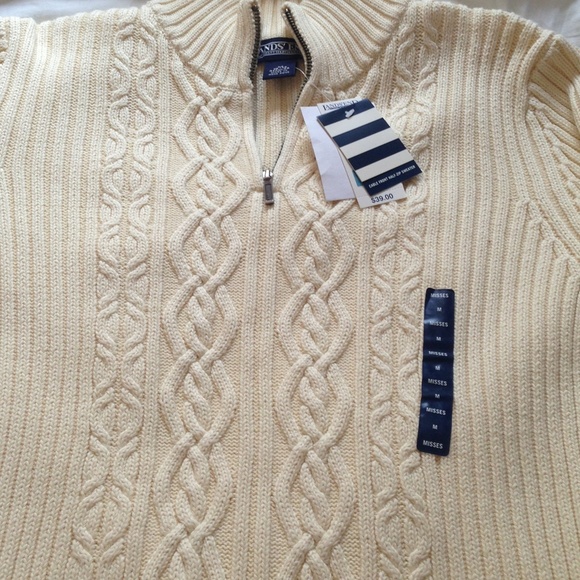 Cream colored cable knit sweater. New with tags .